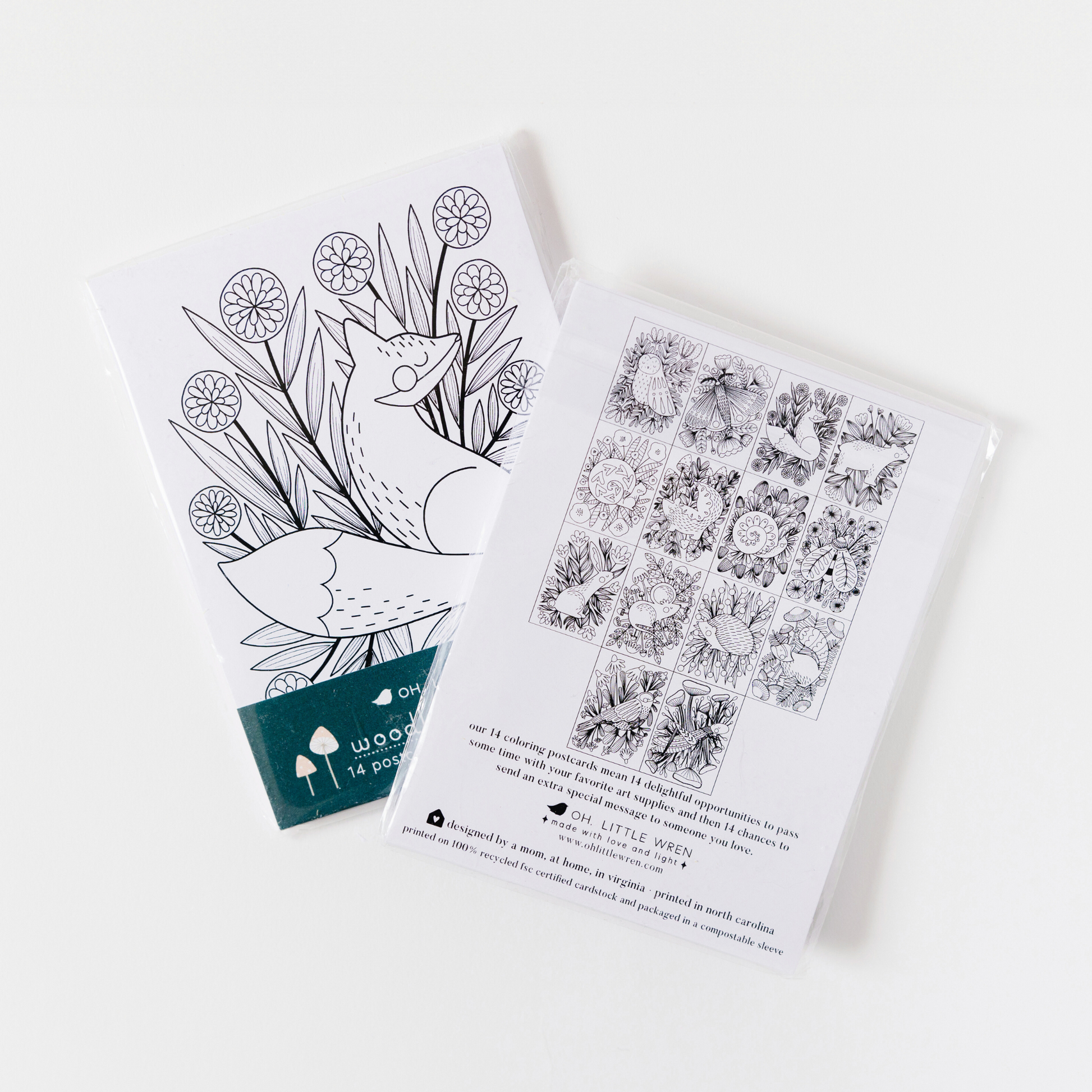 two packs of coloring postcards are arranged on a white background. the first pack shows the front of the packaging, with the fox postcard. the second shows the back of the packing showing all 14 designs.